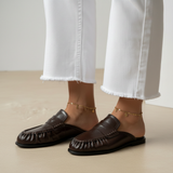 Black mule loafer - hand on heel seated 1:1