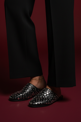Black studded mules - close-up with anklet detail