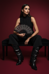 Egyptian model sitting with black pocket boots and anklet